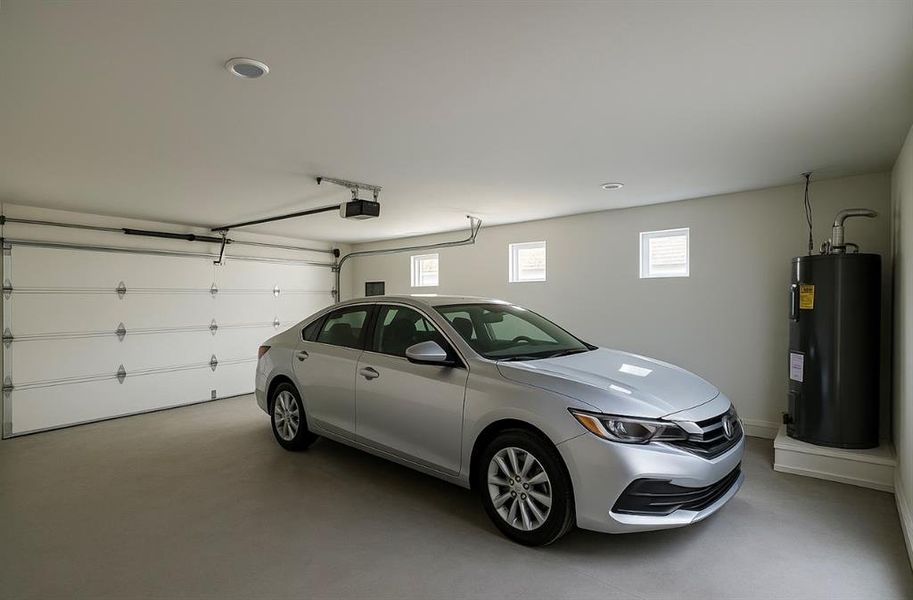 Garage with electric water heater, recessed lighting, and a garage door opener Garage with electric water heater, recessed lighting, and a garage door opener