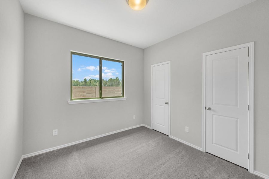 This home features 3 guest bedrooms. 1/3 pictured.