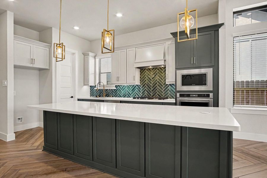 Expansive island with pop up countertop outlets, extra storage and plenty of space for seating. Expansive island with pop up countertop outlets, extra storage and plenty of space for seating.