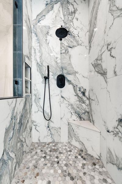 Full bath featuring a marble finish shower