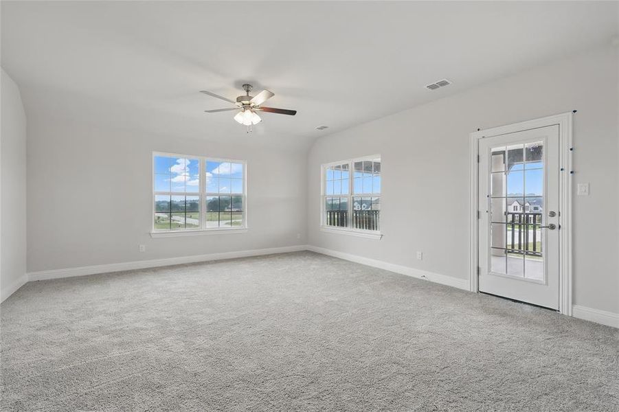 Spare room featuring plenty of natural light, ceiling fan, baseboards, and carpet floors Spare room featuring plenty of natural light, ceiling fan, baseboards, and carpet floors