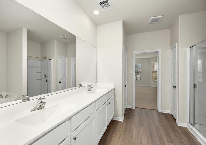 The master bath has a large soaker tub and separate shower.