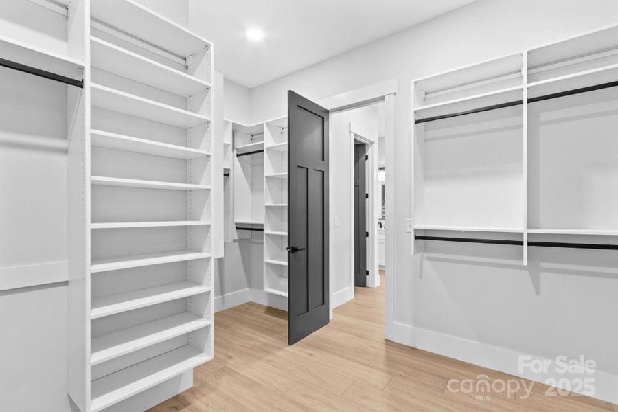 Seller spent $20,000 on custom organizers for all closets & pantry. Another part of main bedroom closet.
