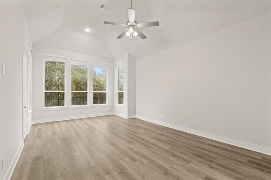 Primary bedroom with sitting extension view of woods