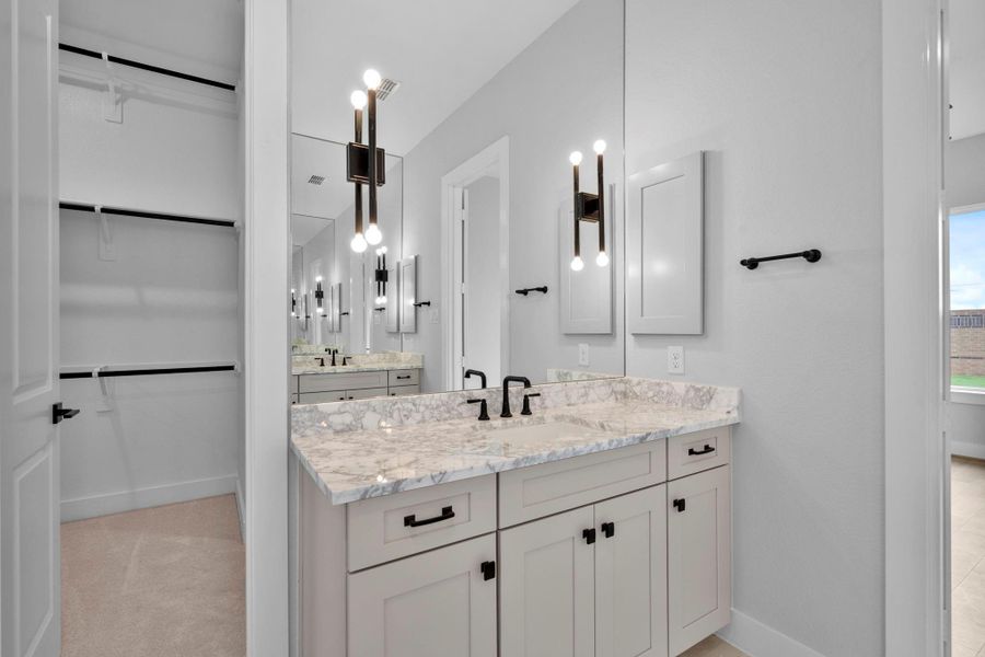 Two granite sinks across from each other in the main bath.