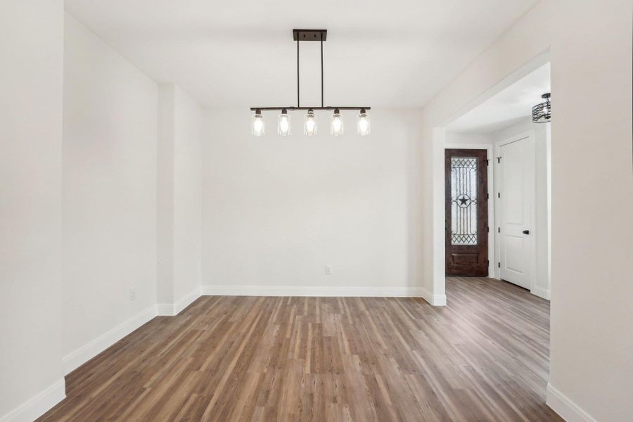 Formal Dining area or office, featuring wood-style vinyl flooring and baseboards Formal Dining area or office, featuring wood-style vinyl flooring and baseboards