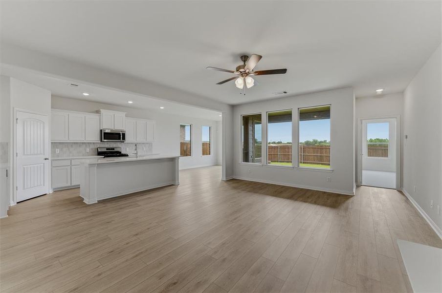 Open concept living area with wood-finish flooring throughout