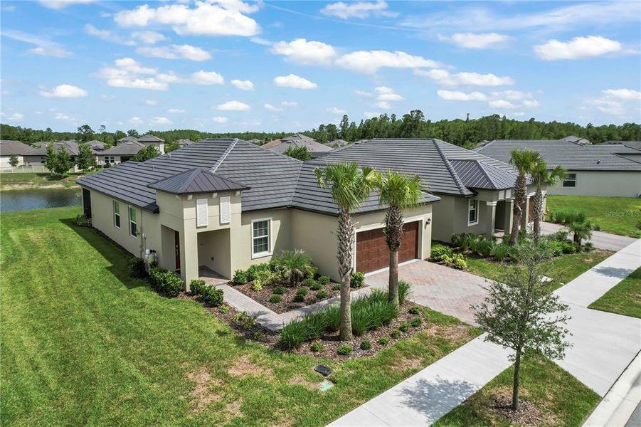 Front exterior of a new home in Angeline Active Adult, Land O' Lakes, FL, highlighting curb appeal (Image 23). Front exterior of a new home in Angeline Active Adult, Land O' Lakes, FL, highlighting curb appeal (Image 23).
