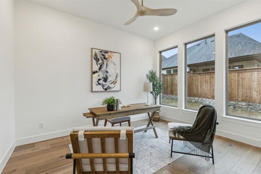 Office featuring ceiling fan, plenty of natural light, and light hardwood / wood-style flooring