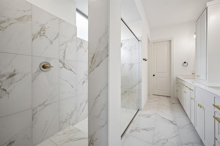 Offering a luxurious walk in shower with drying area, this owner's bath is a dream come true!