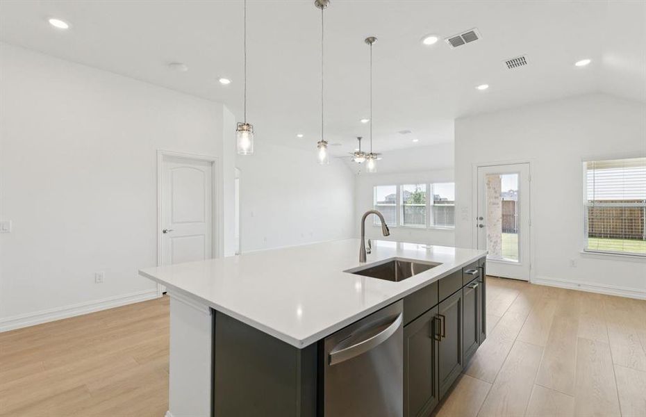 Large island overlooking gathering room and dining areas Large island overlooking gathering room and dining areas