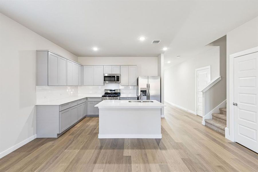 Kitchen in the Haylee home plan by Trophy Signature Homes - REPRESENTATIVE PHOTO Kitchen in the Haylee home plan by Trophy Signature Homes - REPRESENTATIVE PHOTO