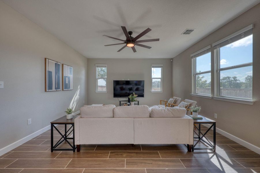 Rich wood-look tile flooring and abundant natural light define this welcoming living space. Rich wood-look tile flooring and abundant natural light define this welcoming living space.