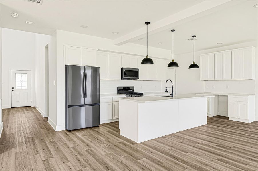 Stunning kitchen featuring white cabinetry, large island, and modern finishes. Stunning kitchen featuring white cabinetry, large island, and modern finishes.