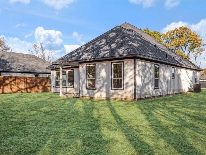 Back of house featuring a shingled roof