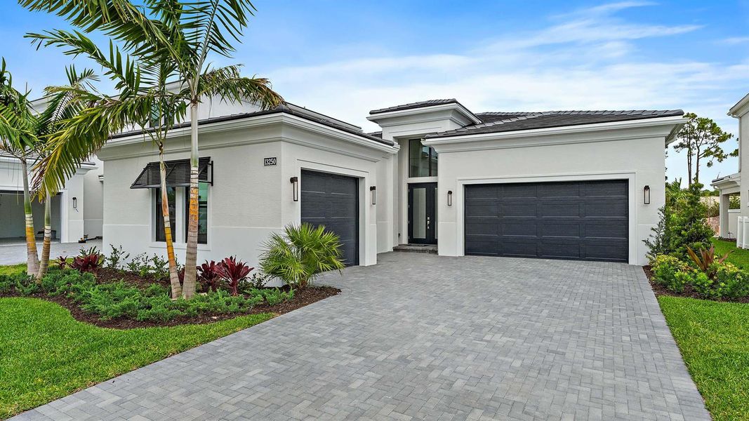 Front exterior of a new home in Artistry Palm Beach, Palm Beach Gardens, FL, highlighting curb appeal (Image 22).