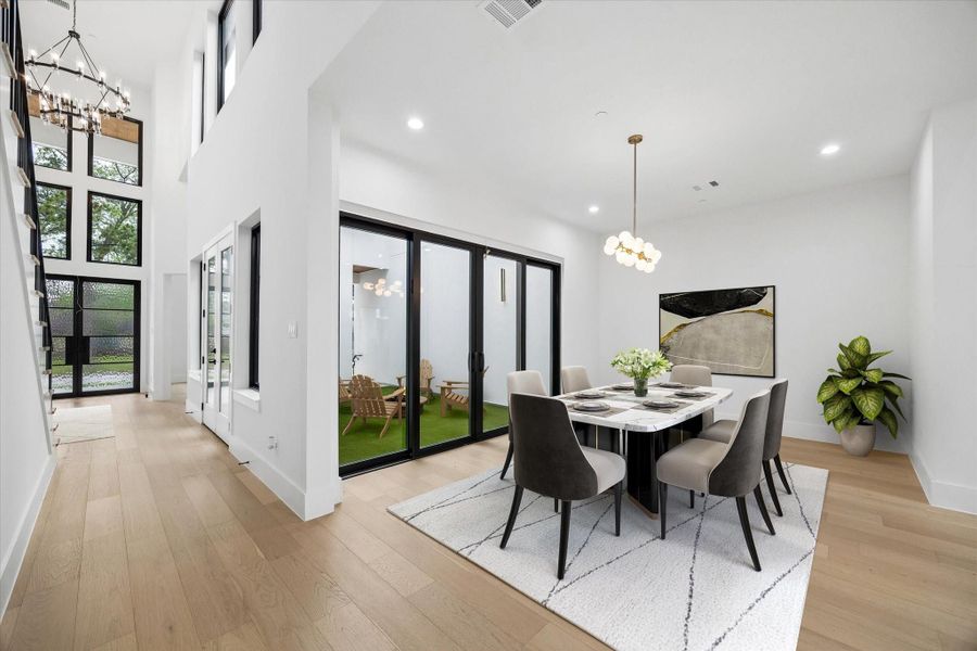 The formal Dining is also connected to the outdoors by tall floor length windows- the center two are the Pella sliders. (virt. staged)