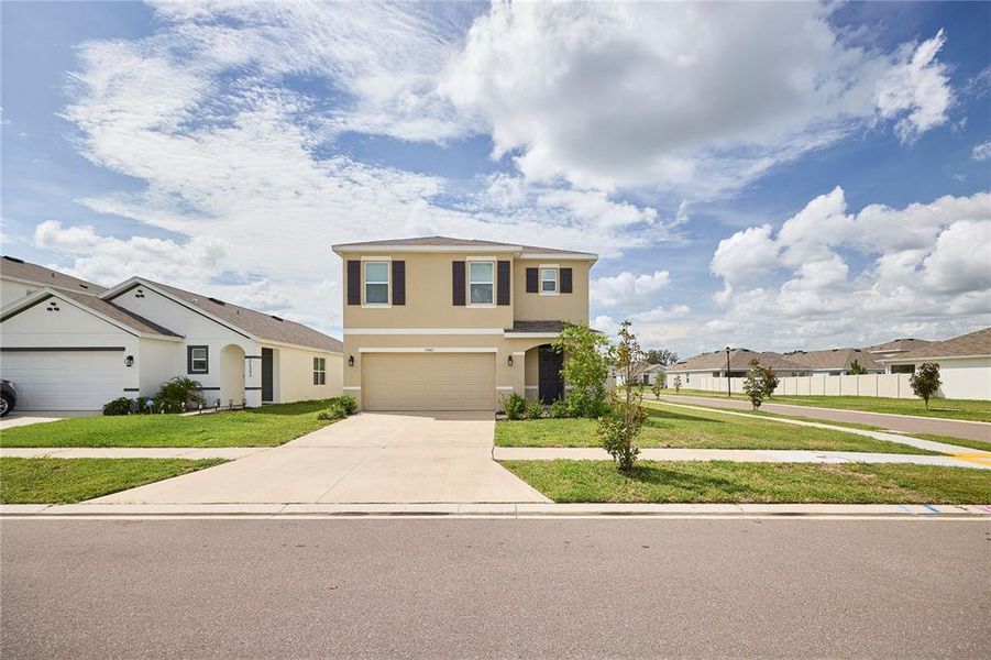 Front exterior of a new home in Westgate at Avalon Park, Wesley Chapel, FL, highlighting curb appeal (Image 25).