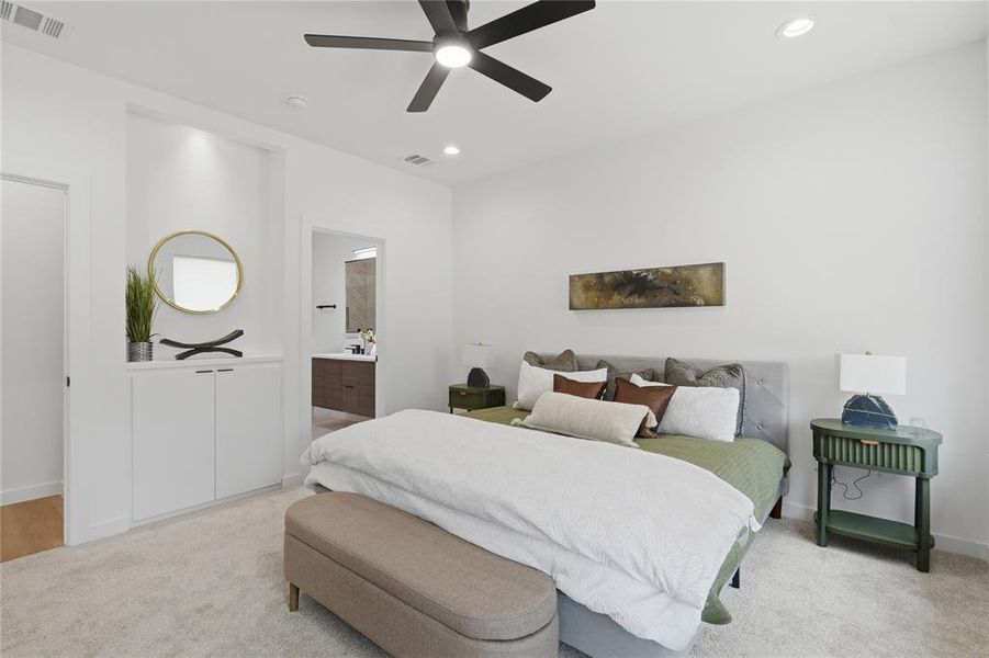 Bedroom with light colored carpet, recessed lighting, and a ceiling fan Bedroom with light colored carpet, recessed lighting, and a ceiling fan