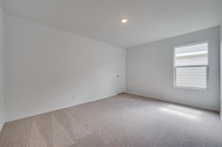 Unfurnished room with carpet flooring and plenty of natural light Unfurnished room with carpet flooring and plenty of natural light