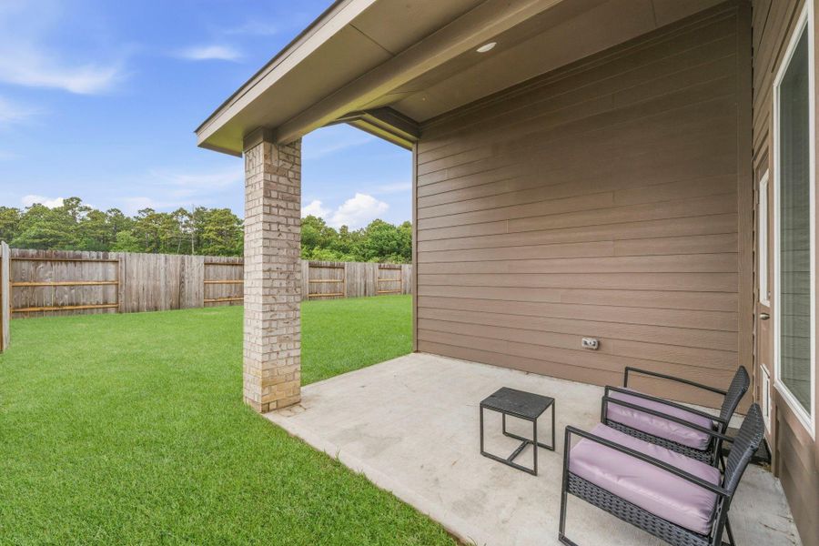 Enjoy peaceful evenings and morning coffee under this covered patio overlooking the expansive backyard. Enjoy peaceful evenings and morning coffee under this covered patio overlooking the expansive backyard.
