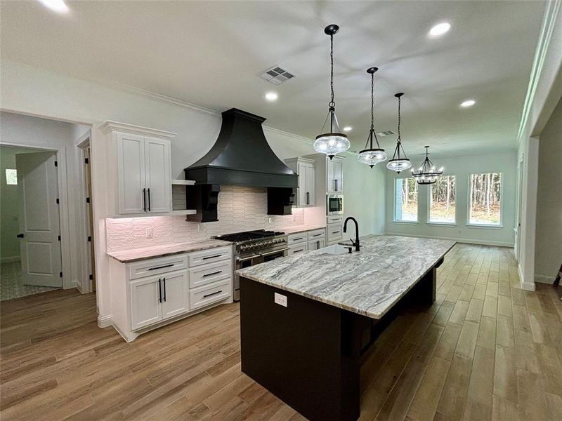 Entry with vaulted ceiling, beam and custom trim and wainscoting