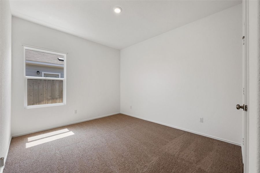 Carpeted empty room featuring baseboards Carpeted empty room featuring baseboards