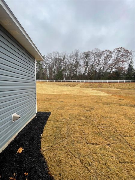 Exterior details and patio area of a home in Springwood Grove, Central (Image 4).