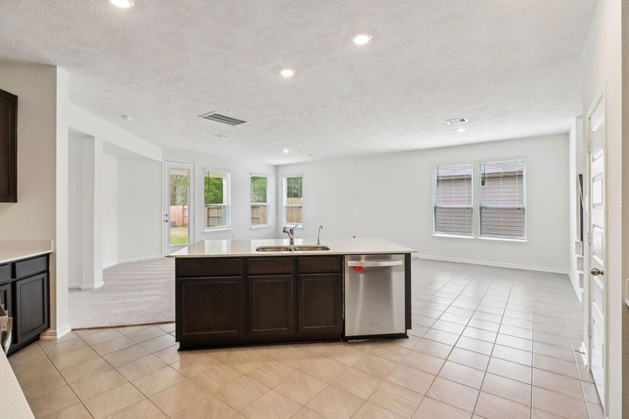 A commanding view of the open-concept design which seamlessly connects the living, dining, and kitchen areas—perfect for both everyday living and entertaining!