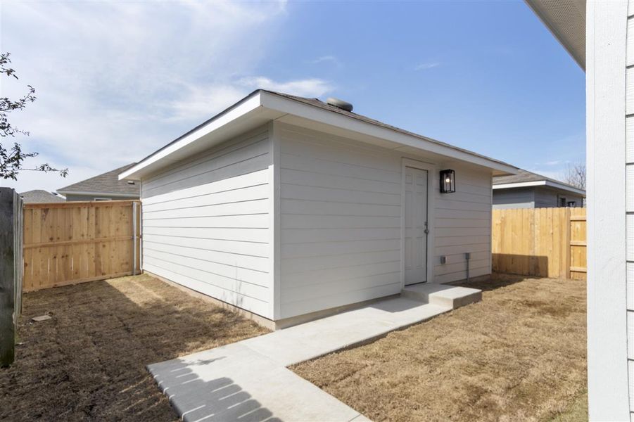 View of side of home featuring a fenced backyard