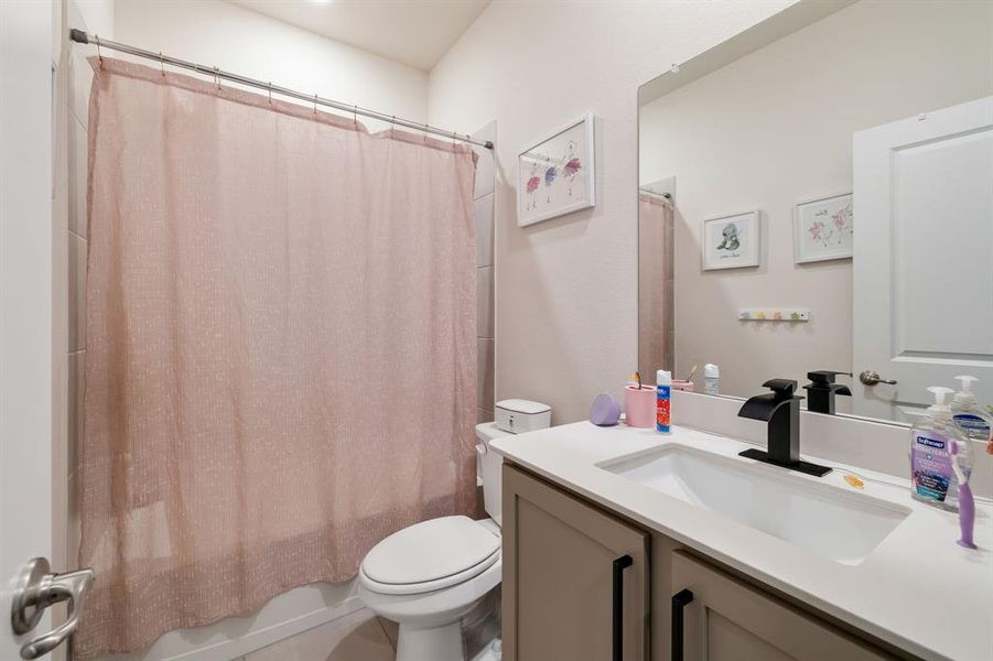 Bathroom with shower / bath combination with curtain and vanity Bathroom with shower / bath combination with curtain and vanity