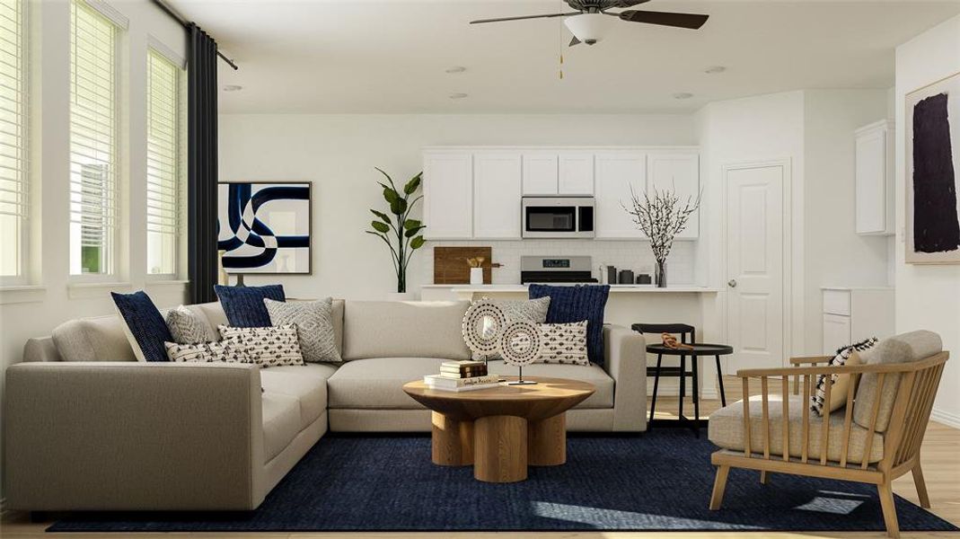 Living room featuring ceiling fan and hardwood / wood-style flooring