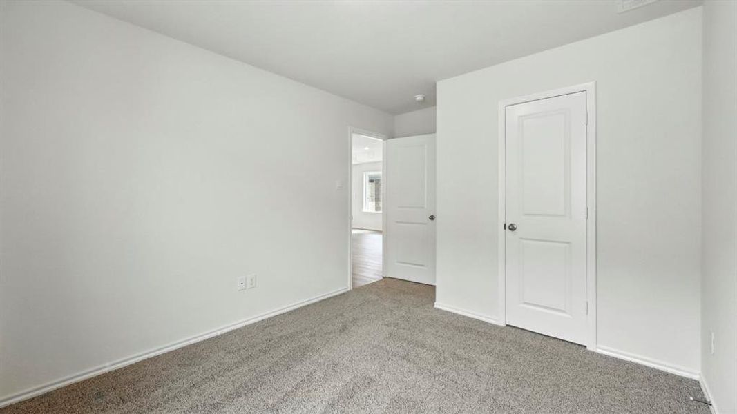Neutral tone paint, grey carpet, white baseboards, and paneled interior doors Neutral tone paint, grey carpet, white baseboards, and paneled interior doors