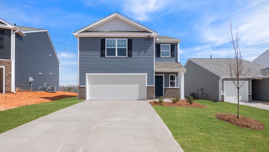 Front exterior of a new home in Stone Creek, Clinton, SC, highlighting curb appeal (Image 1).