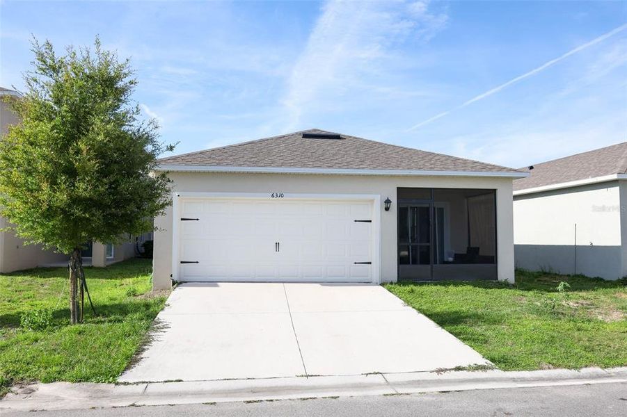 Front exterior of a new home in Windrose, Apopka, FL, highlighting curb appeal (Image 24).