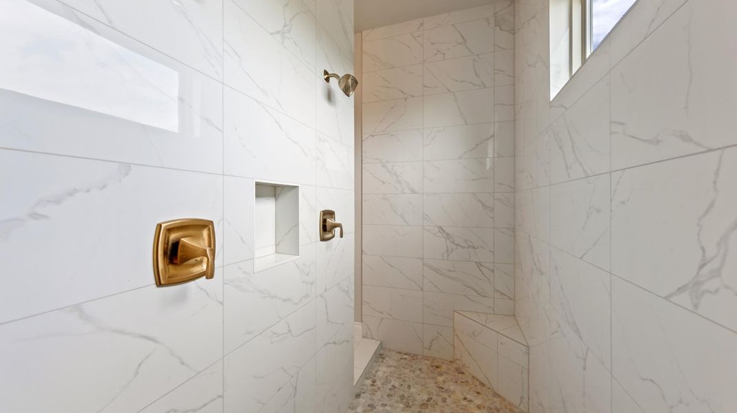 Full bathroom with a marble finish shower