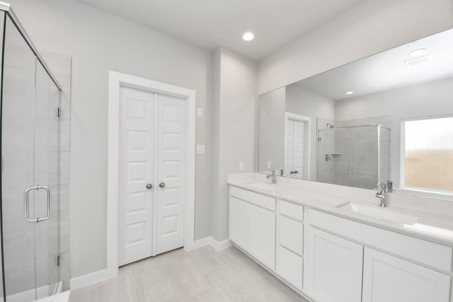 Elevate your daily routine at the refined vanity, now boasting double sinks, light-toned countertops, modern hardware, and captivating recessed lights. Elevate your daily routine at the refined vanity, now boasting double sinks, light-toned countertops, modern hardware, and captivating recessed lights.