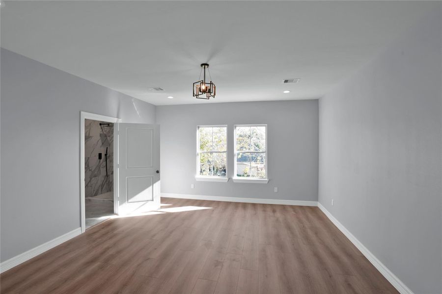 Primary room with en-suite bath and  two walk-in closets with cabinetry