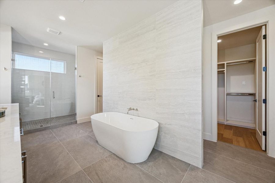 The ensuite bath offers two walk-in closets with built-ins, along with an extra storage closet that would make the perfect accessory closet, shoe closet or storage for luggage.