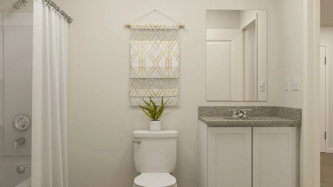 A bathroom with a plant on the toilet.