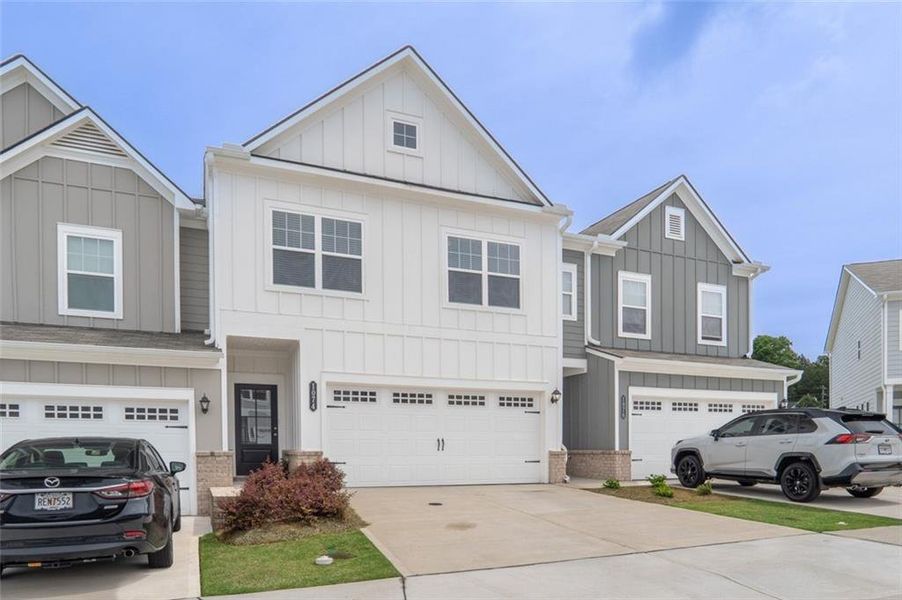 Front exterior of a new home in Ellison Square, Sugar Hill, GA, highlighting curb appeal (Image 21). Front exterior of a new home in Ellison Square, Sugar Hill, GA, highlighting curb appeal (Image 21).