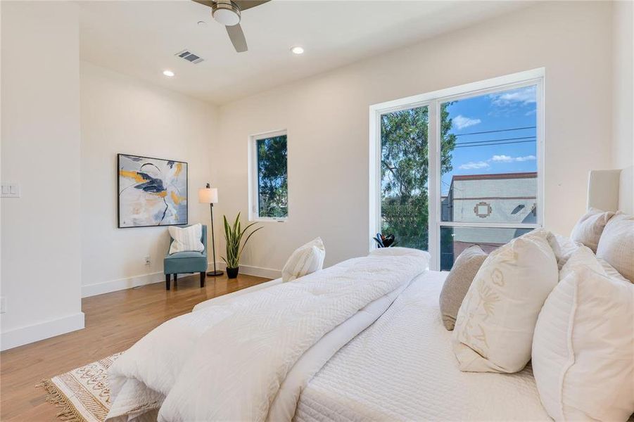 Bedroom with ceiling fan and wood-type flooring