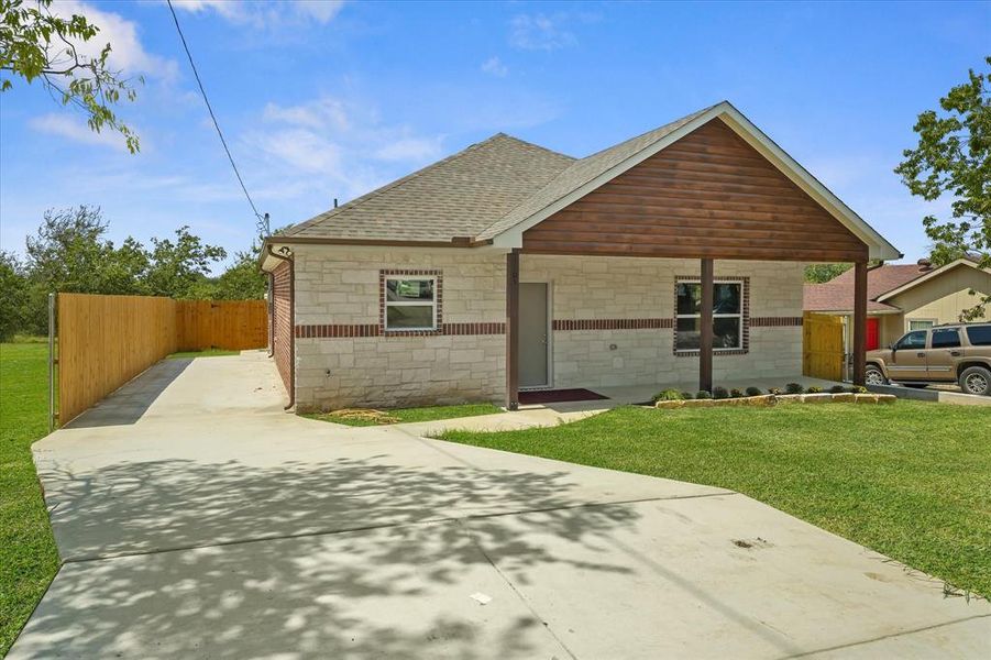 View of front facade featuring roof with shingles and driveway View of front facade featuring roof with shingles and driveway