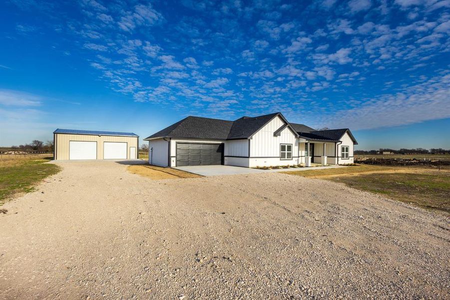 View of front of house featuring an outbuilding and a garage