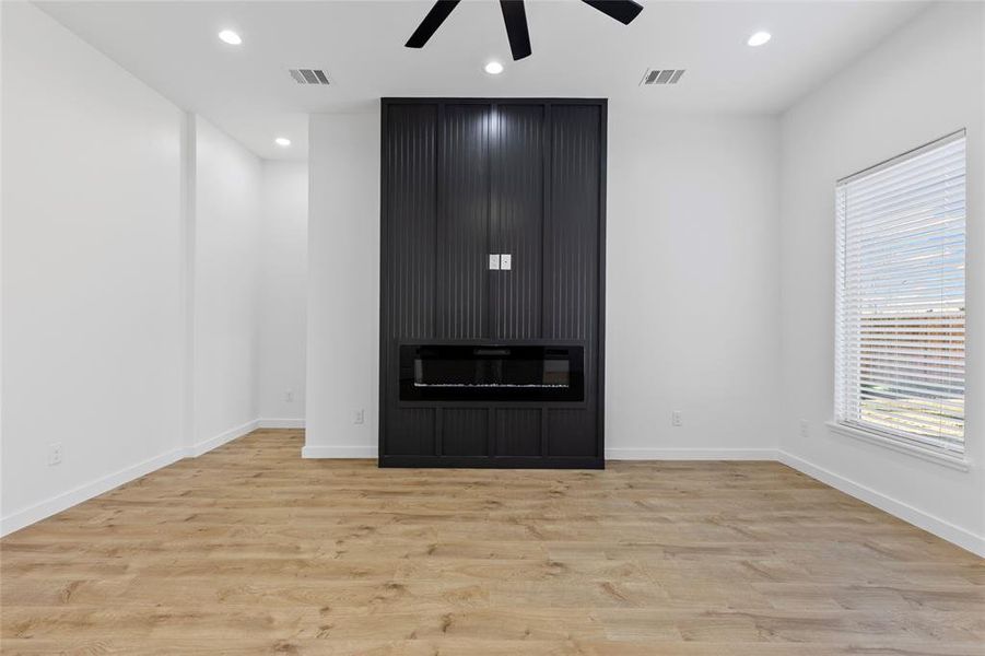 Unfurnished living room featuring recessed lighting, wood finished floors, and visible vents