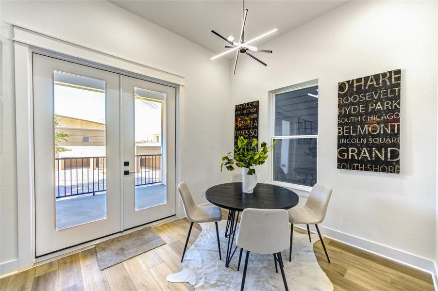 This bright dining area. Large glass doors open to a balcony, enhancing natural light.