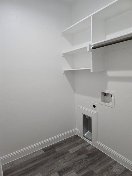 Laundry area with electric dryer hookup, hookup for a washing machine, and dark wood-type flooring