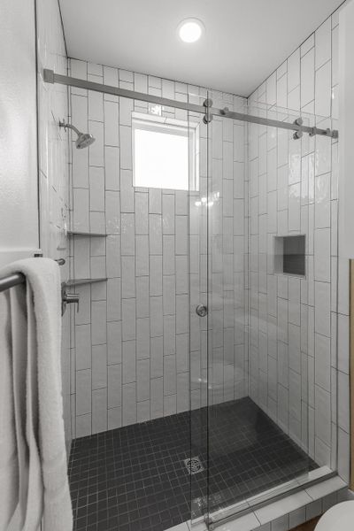 Bathroom featuring a shower stall Bathroom featuring a shower stall