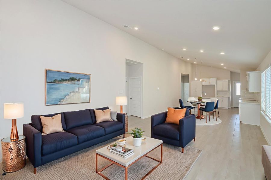 Large windows allow for an abundance of natural light to flood the room, while durable and stylish light wood-toned flooring flows seamlessly throughout the space. Large windows allow for an abundance of natural light to flood the room, while durable and stylish light wood-toned flooring flows seamlessly throughout the space.