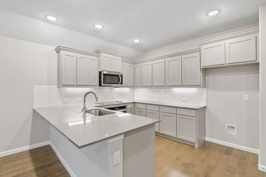 Kitchen in the Pulitzer home plan by Trophy Signature Homes – REPRESENTATIVE PHOTO